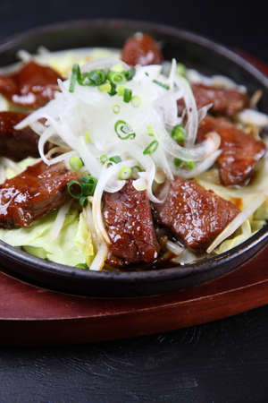 beef skirt steak on a iron plateの写真素材