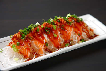 salmon carpaccio in spicy hot sauceの写真素材