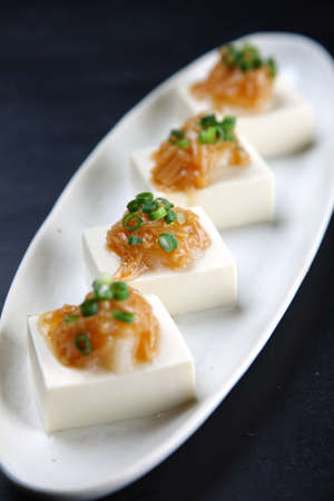mushrooms on tofu with choped onionの写真素材