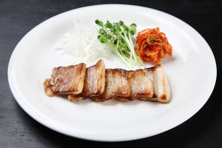 thinly sliced pork rib saute with kimchiの写真素材