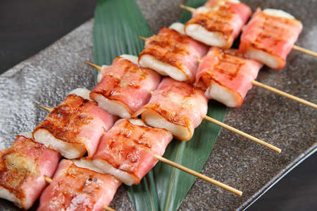 bacon with rice cake skewersの写真素材
