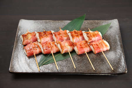 bacon with rice cake skewersの写真素材
