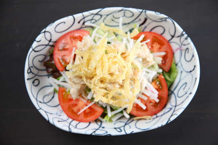 chicken with radish salad on dark backgroundの写真素材