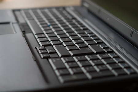 a note on the desktop. closeup on the keyboard of the laptop.