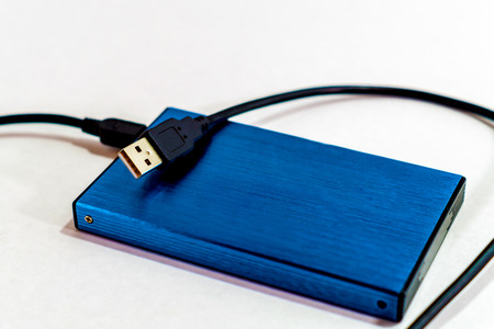a external harddisk and cable on the deskの写真素材
