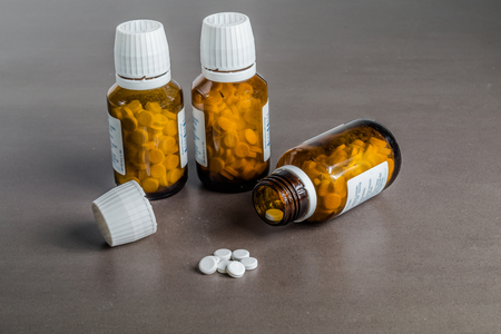 Close up of pills on the nightstand. Three glasses with pills.の写真素材