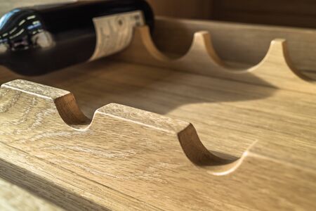 Selective focus on wooden shelf and bottle in background. With copy space.の写真素材