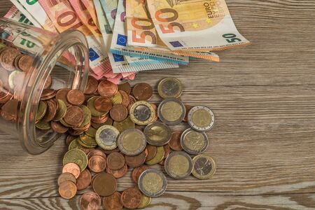 Euro paper money and coins on wooden table.の写真素材