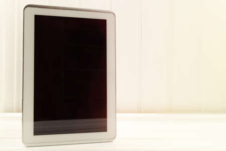 Empty tablet pc on a wooden desk.の写真素材
