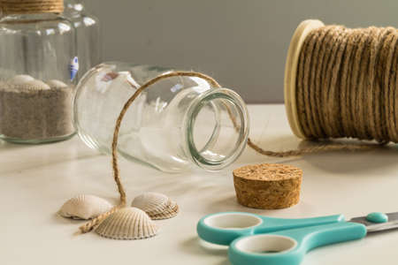 Handmade glass diy project. With scissors, cord and shellfish. Creative diy concept.の写真素材