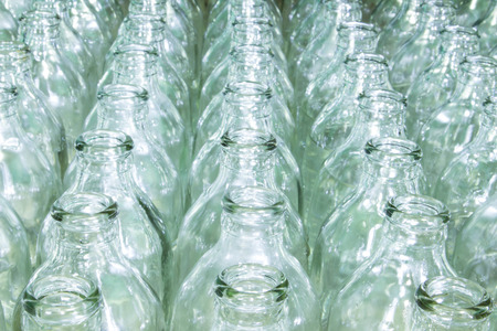 Clear glass bottle filled with water placed at different vertical opening.の写真素材