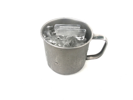 Ice in stainless cup on isolatedの写真素材