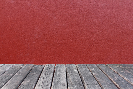 wood table on red wall concrete backgroundの写真素材