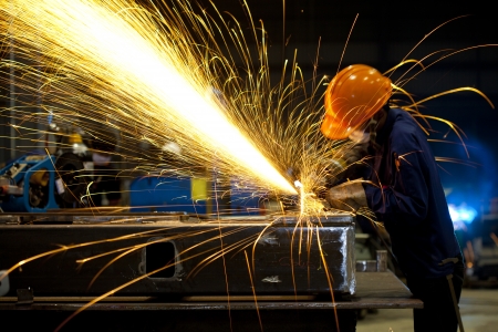 Factory worker using electric grinder - a series of METAL INDUSTRY images の写真素材