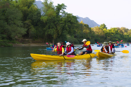 traveler in vang vieng use time relaxtion floating on river song evening timeのeditorial素材