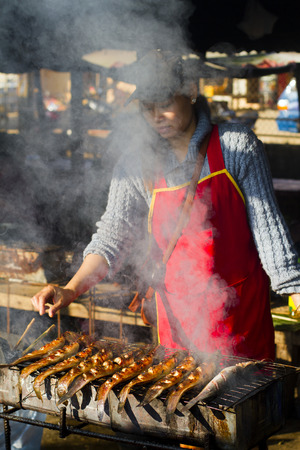 Villagers burned alive catfish Vang Vieng  laos のeditorial素材