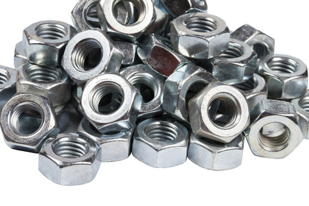 Chromed screw nuts from above. Screw nuts of different sizes on a gray background.