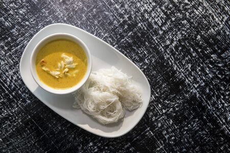 Yellow curry with crab and white noodle, Famous traditional food Thailand.