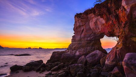 Natural hole on colorful rocks at Laem Chamuk Khwai in Khao Thong,Mueang Krabi District,Krabi province,southern Thailand.の写真素材