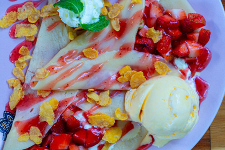 Waffles with strawberries with ice cream. Extra honey on white plate.の写真素材