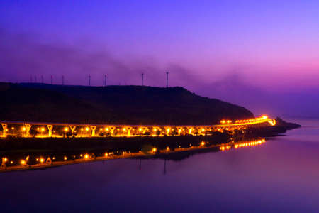 Long Exposure of Car Lights on Motorway Meandering through Hills at Sunset, Lam Ta Khong Motorway.の写真素材