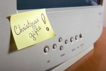 christmas gifts on yellow memo at monitorの写真素材