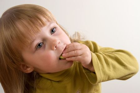 young pretty girl eating with emotionsの写真素材