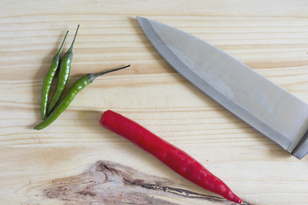 Sliced red pepper on a wooden cutting board and knife.