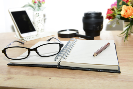 Business planning with copy space and office supplies.Have Blurry mobile and magnifying glasses ,mobile and glasses on wood background as props.の写真素材