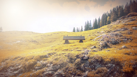 Fantasy fable scene effects applied. Bench on side walk by the Lake in the Europe and in the mountain.の写真素材