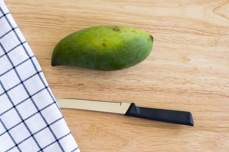 Whole Green Mango on a wooden table.の写真素材