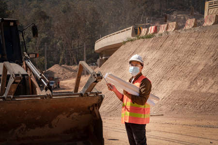 Surveyor builder Engineer technician  Business Team looking for blueprints in construction sites...