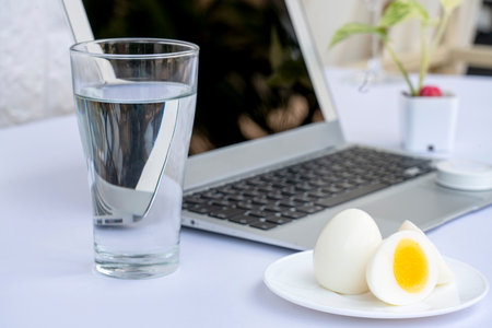 Glass of milk with boiled eggs isolated on white background. Dairy free milk substitute drink, diet...