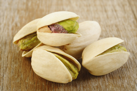 pistachios on wooden table backgroundの写真素材