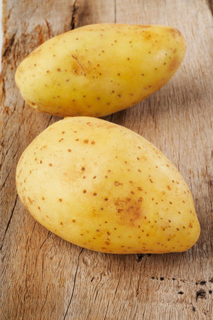 Potato vegetable on wooden backgroundの写真素材