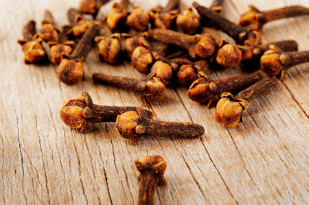 Cloves herb on wooden backgroundの写真素材