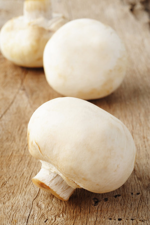 Champignon mushroom on wooden backgroudの写真素材