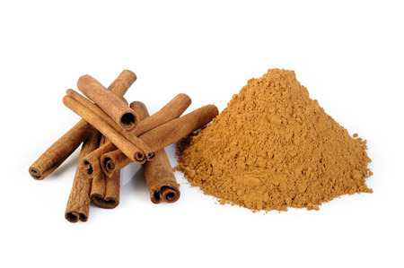 Cinnamon sticks and powder on white backgroundの写真素材