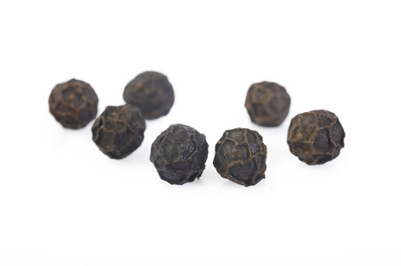 Black pepper seeds on white backgroundの写真素材