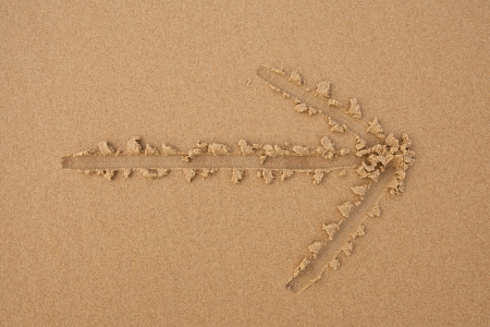 Drawn arrow on the sand