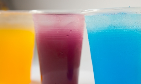 Colorful sweet fruit juice in plastic glassの写真素材