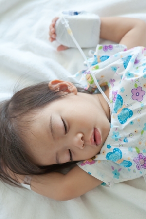 little boy patient sleeping in hospitalの写真素材