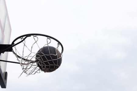 A view of a basketball hoop from belowの写真素材