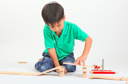 boy building  with colorful wooden blocks. Studio shot,の写真素材