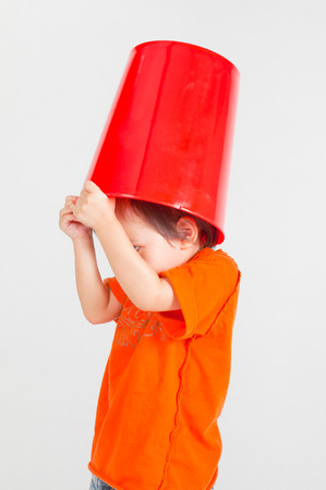 Young boy with a bucket on his head,in Studio shot,rgの写真素材