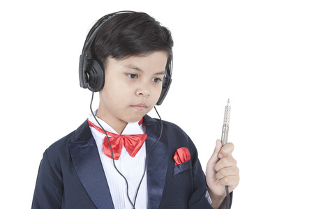 Portrait of little business boy in headphonesの写真素材