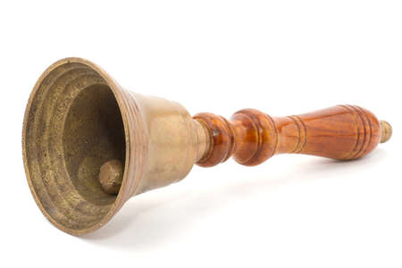 Handbell lying on a white surfaceの写真素材