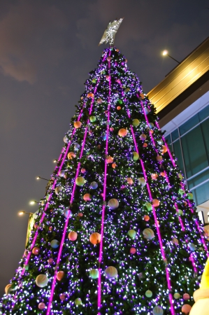 Artificial christmas tree with light and ornament at nighttimeの写真素材