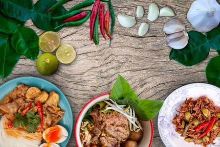 Thai food and ingredients placed on a wooden plank