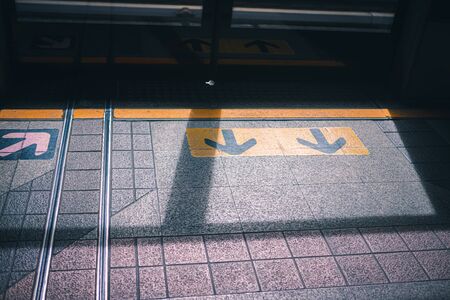 The arrow symbol for the entrance and exit of the passengers in the sky train BTS station.の写真素材
